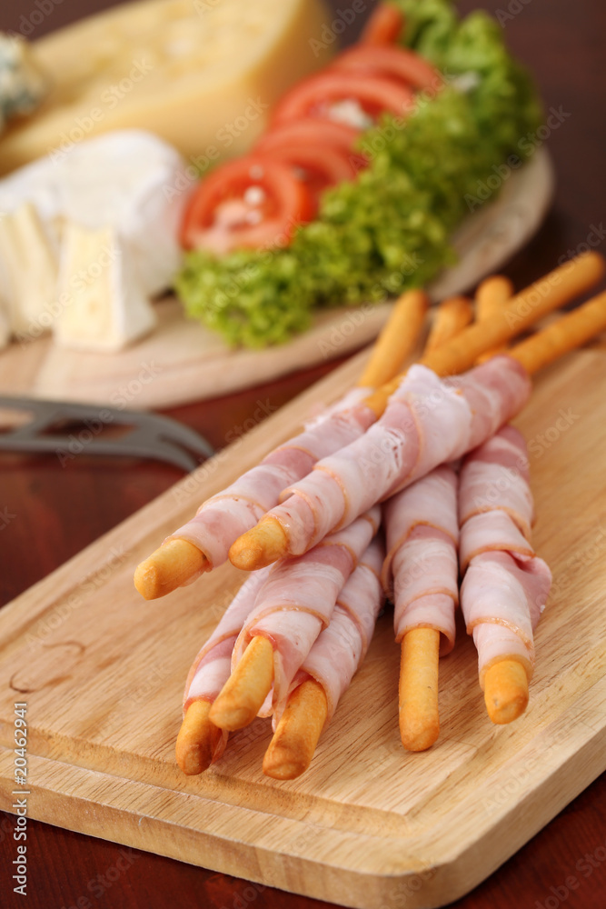 Bacon wrapped grissini breadsticks and cheese Bacon wrapped grissini breadsticks and cheese