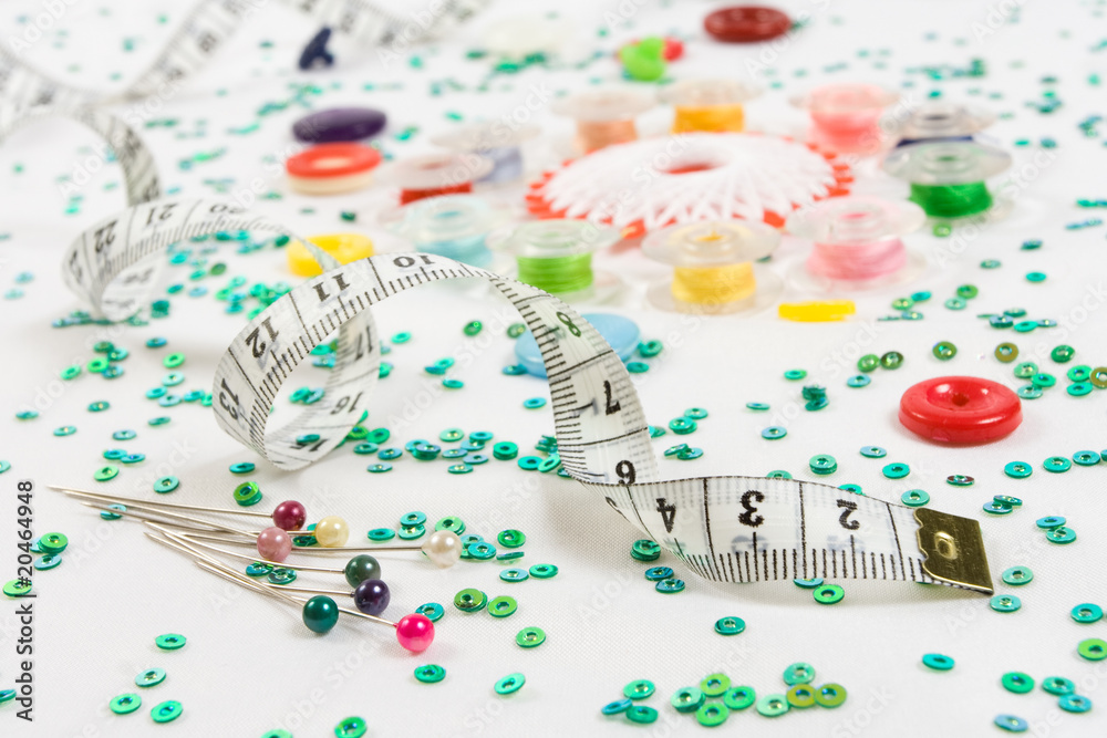 sewing background: buttons, bobbins, ruler, needles and beads sewing background: buttons, bobbins, ruler, needles and beads