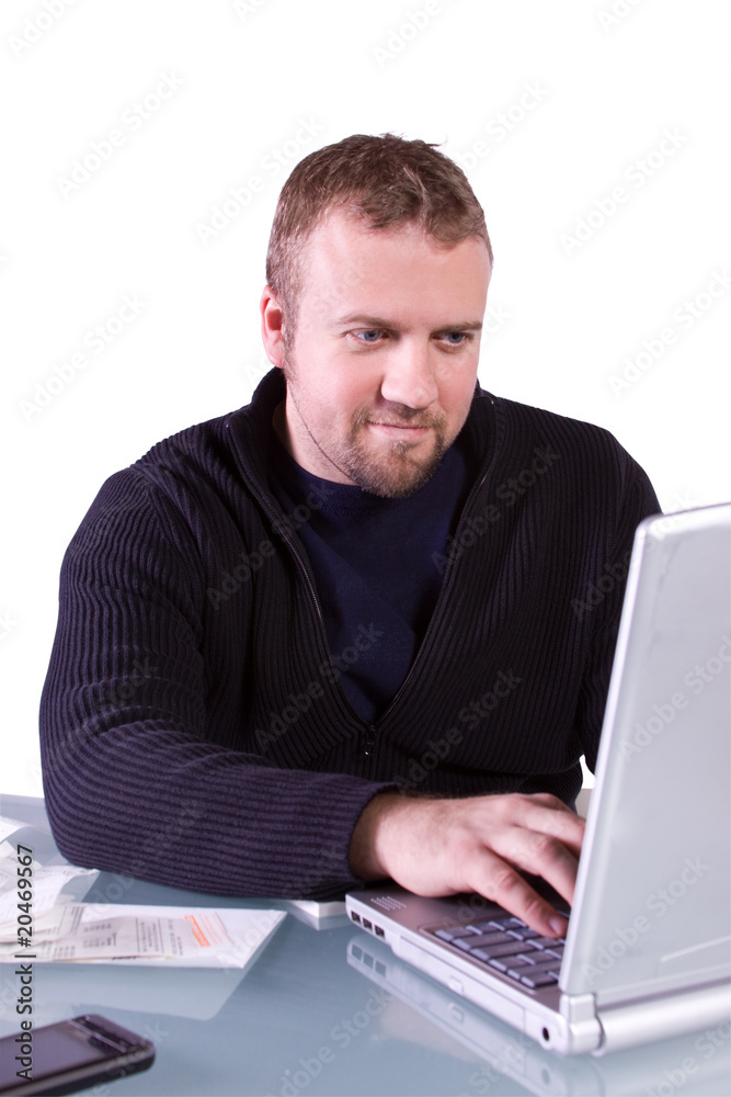 Young Casual Businessman Working at his Desk Young Casual Businessman Working at his Desk