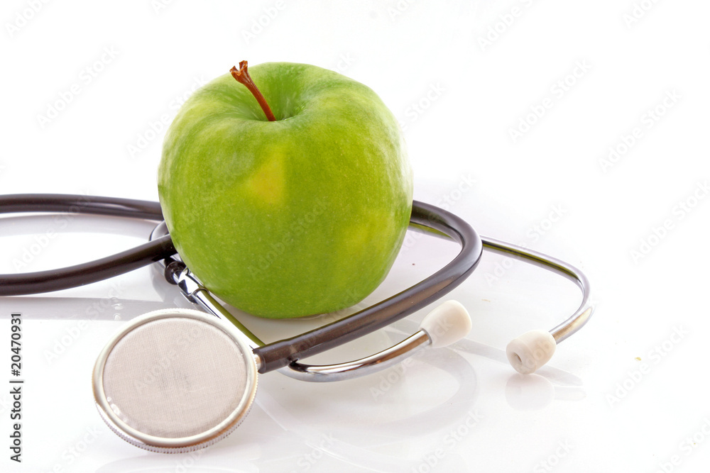 Stethoscope and green apple on white background Stethoscope and green apple on white background