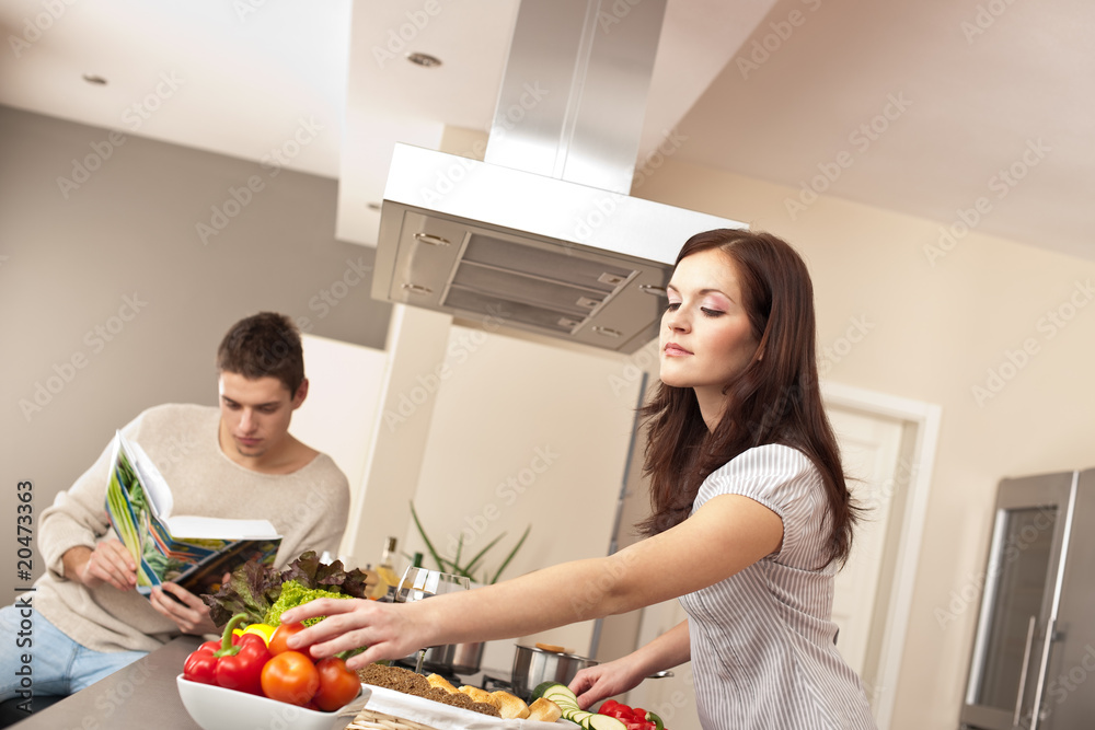 Young couple cooking in kitchen together Young couple cooking in kitchen together