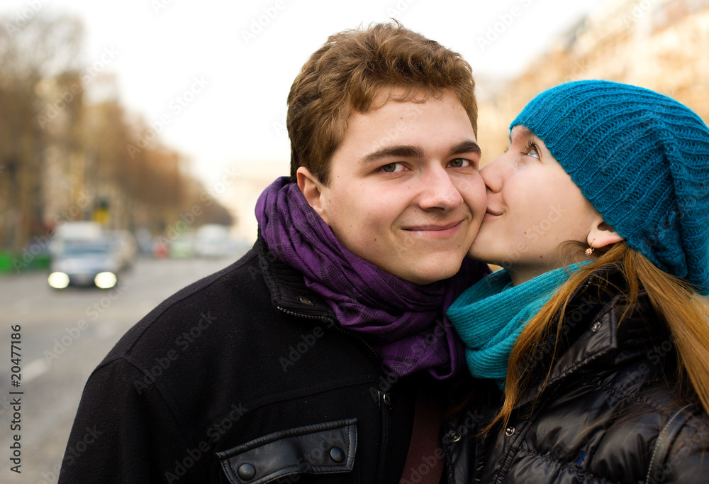 Happy couple in love kissing on the street Happy couple in love kissing on the street