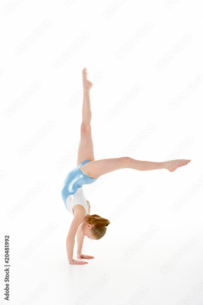 © Monkey Business - Studio Portrait Of Young Female Gymnast