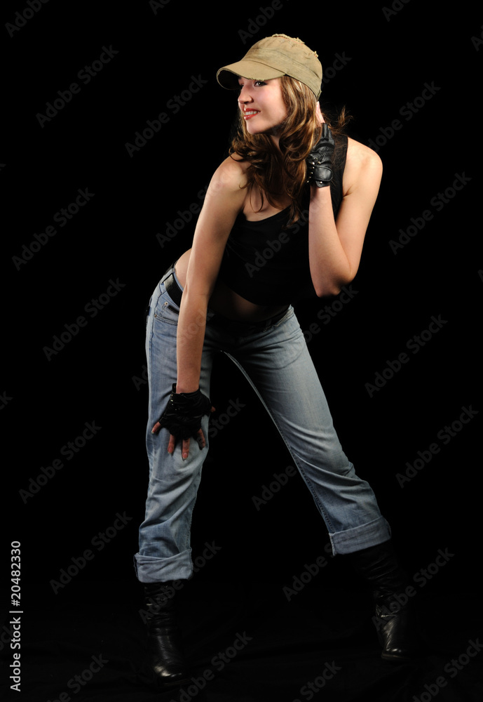 The woman in jeans and a stylish cap The woman in jeans and a stylish cap