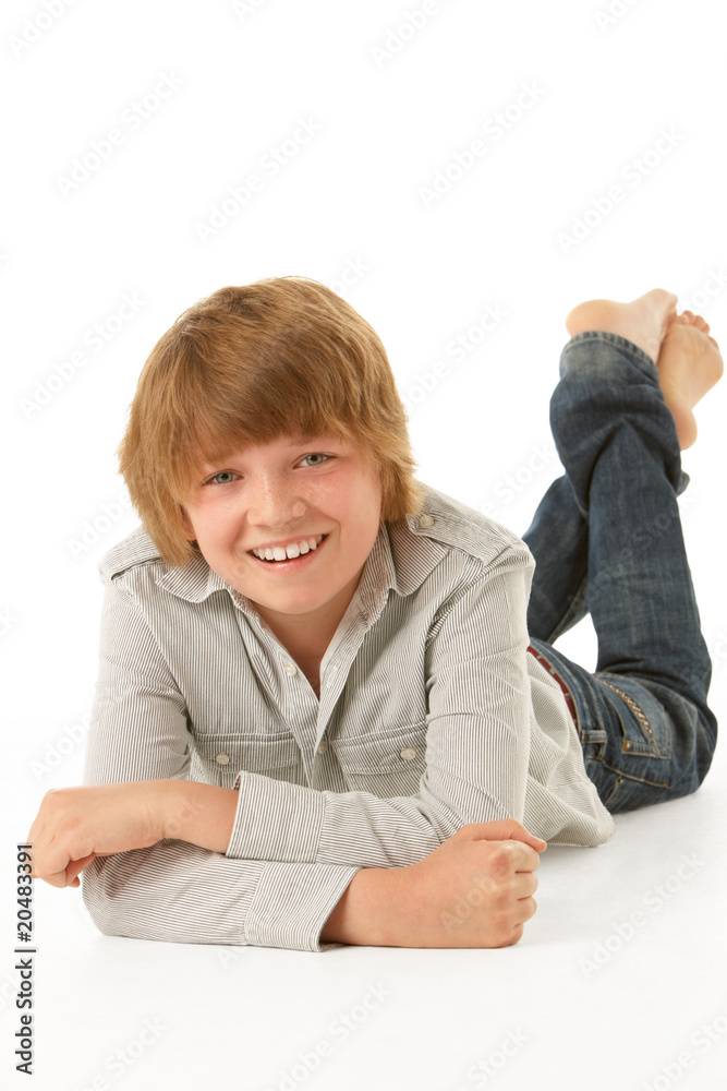 Young Boy Lying On Stomach In Studio Young Boy Lying On Stomach In Studio