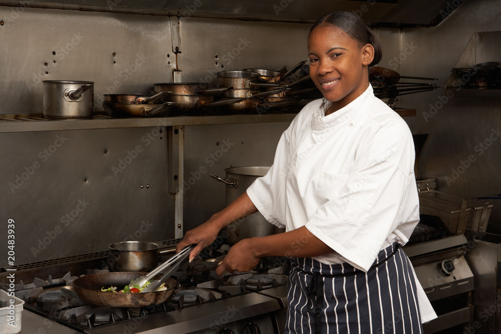 Female Chef Preparing Meal On Cooker In Restaurant Kitchen Female Chef Preparing Meal On Cooker In Restaurant Kitchen