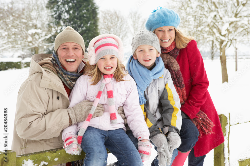 Family Sitting In Snowy Landscape