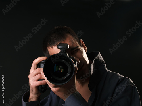 male photographer with full frame camera in studio photo