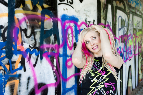 portrait of young woman at graffitti wall