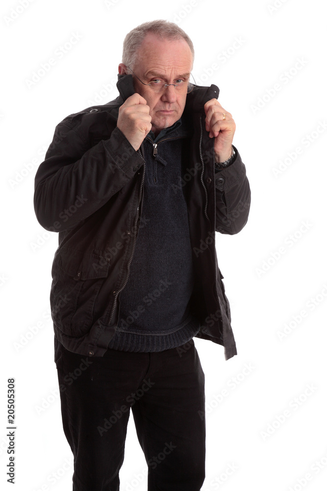 Mature man pulling his coat collar up Mature man pulling his coat collar up
