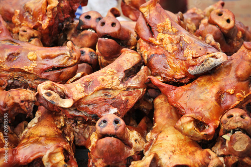 Grilled pig heads at ecuadorian farm market