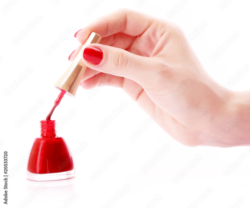 Fototapeta premium Woman hands and varnish bottle isolated on white