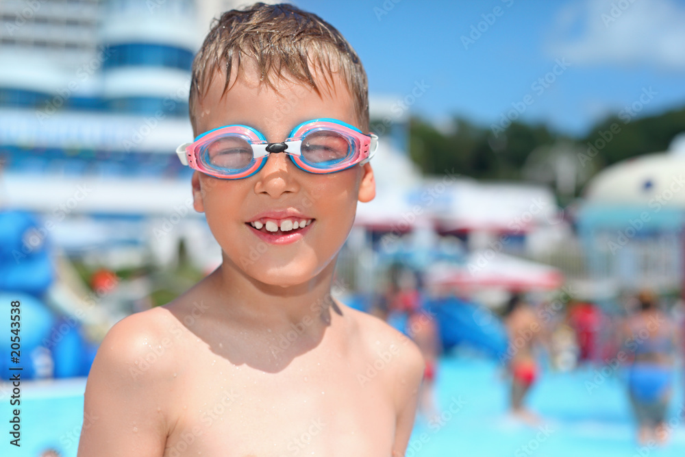 boy in watersport goggles near pool in aquapark boy in watersport goggles near pool in aquapark