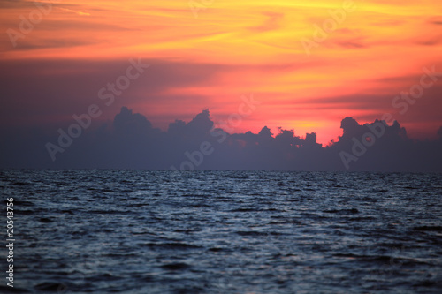Orange drama sunset over dark gloomy sea © Pavel Losevsky
