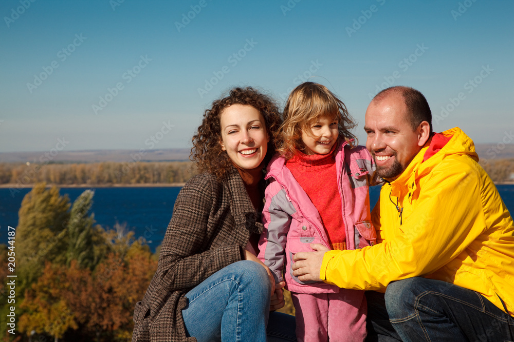 Little girl with mum and daddy, in bright autumn day Little girl with mum and daddy, in bright autumn day