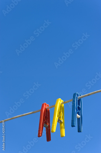 Clothes Pegs Against Bright Blue Sky