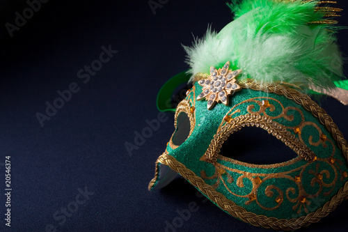 green and gold mask on dark  background
