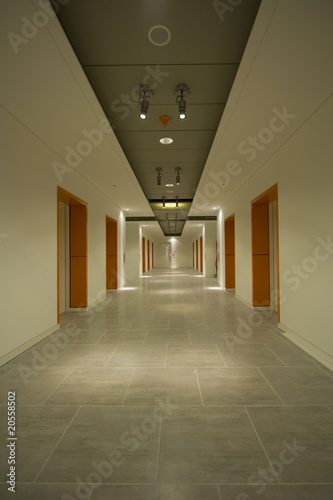 Long white corridor with orange doors