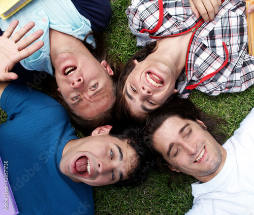 Young guys and girls lying on grass