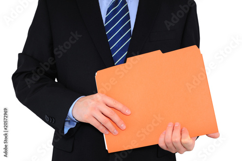 Businessman is holding an orange folder with paperwork