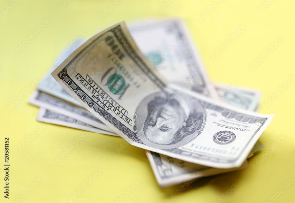 Dollars. Some piece of money over yellow background. Dollars. Some piece of money over yellow background.