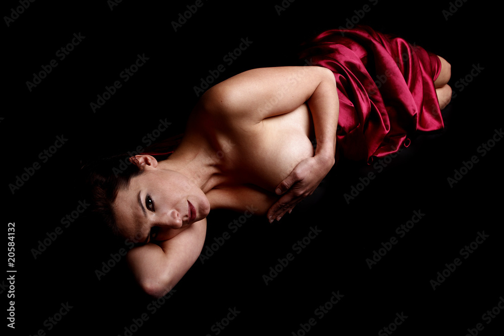 Beautiful woman covered in red satin sheet. Beautiful woman covered in red satin sheet.