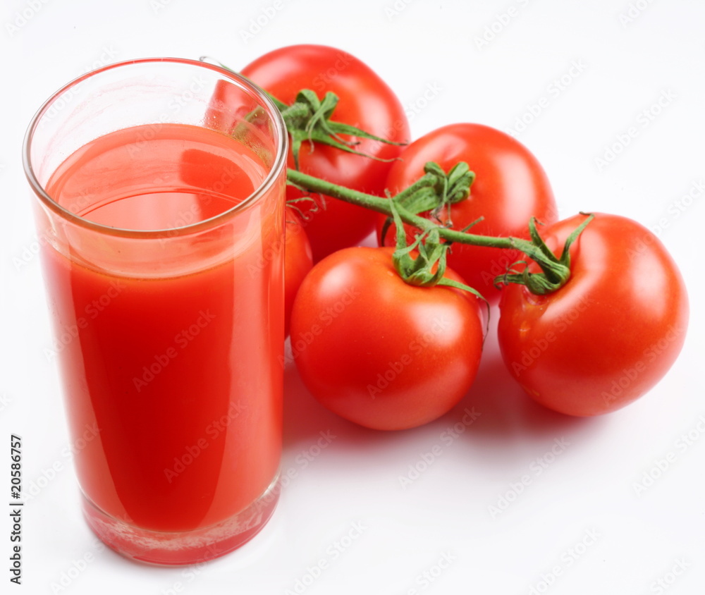 Glass of tomato juice and ripe tomatoes Glass of tomato juice and ripe tomatoes