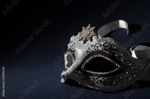 black and silver mask on a black background