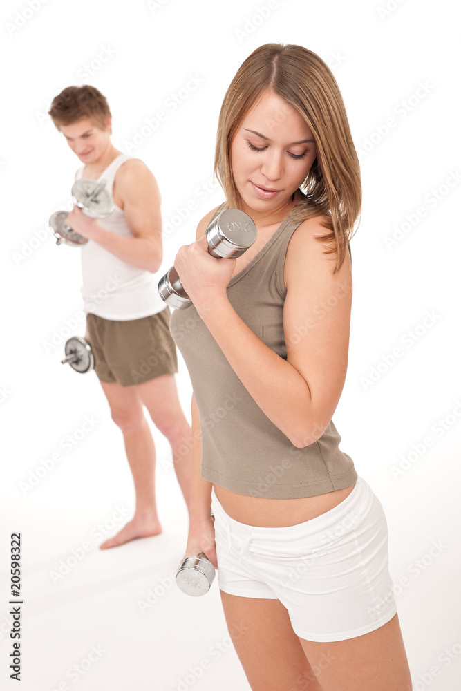 Fitness - Young couple training lifting weights on white Fitness - Young couple training lifting weights on white