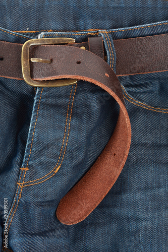 Blue jeans with old brown belt