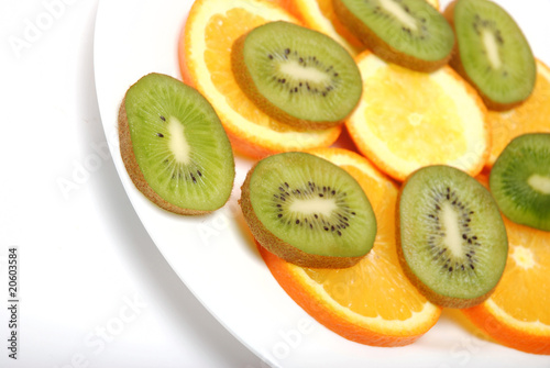 circle slices of kiwi and orange isolated