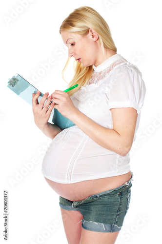 pregnant woman writing a note