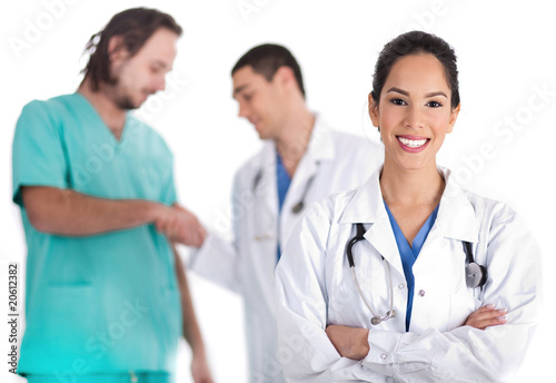 young doctor smiling  other doctor giving shakehand to nurse