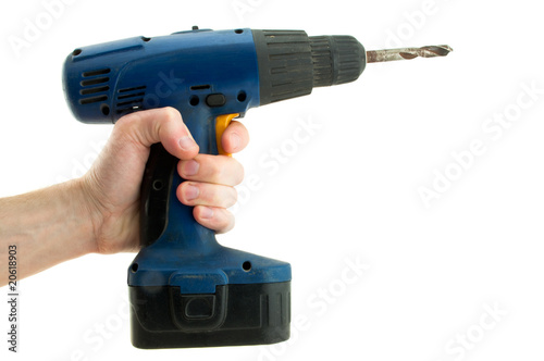 Cordless screwdriver in his hand