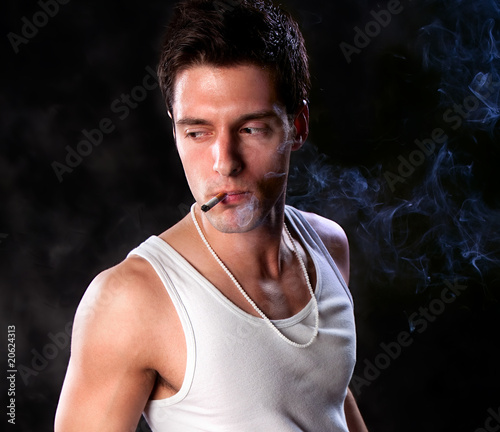 A portrait about a trendy cute guy who is smoking