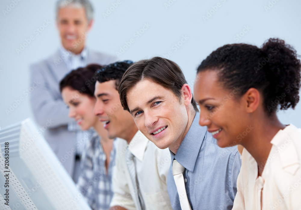 Young business people at work with their manager Young business people at work with their manager