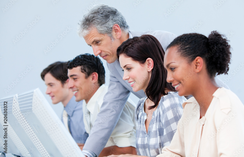 Confident mature manager checking his employee's work Confident mature manager checking his employee's work