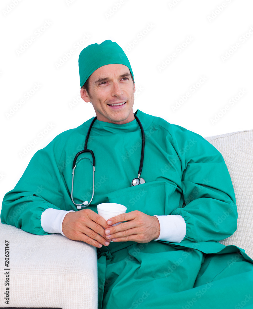 Handsome surgeon drinking coffee in the staff room Handsome surgeon drinking coffee in the staff room