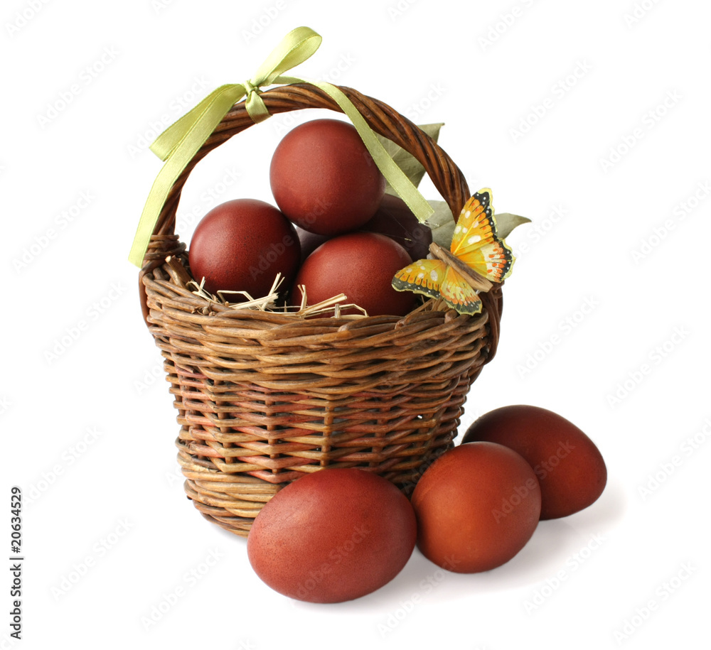 The red colored eggs and a butterfly in a basket The red colored eggs and a butterfly in a basket