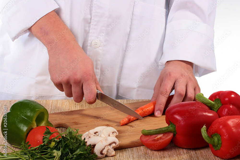Cook cuts carrots Cook cuts carrots