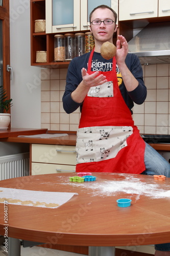 Man in the domestic kitchen with dough in his hands