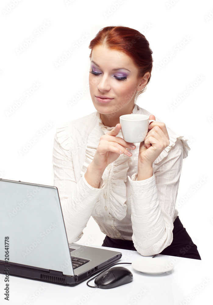 Business woman working on her laptop and drinking coffee. Business woman working on her laptop and drinking coffee.