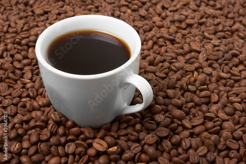 Cup with coffee, costing on coffee grain