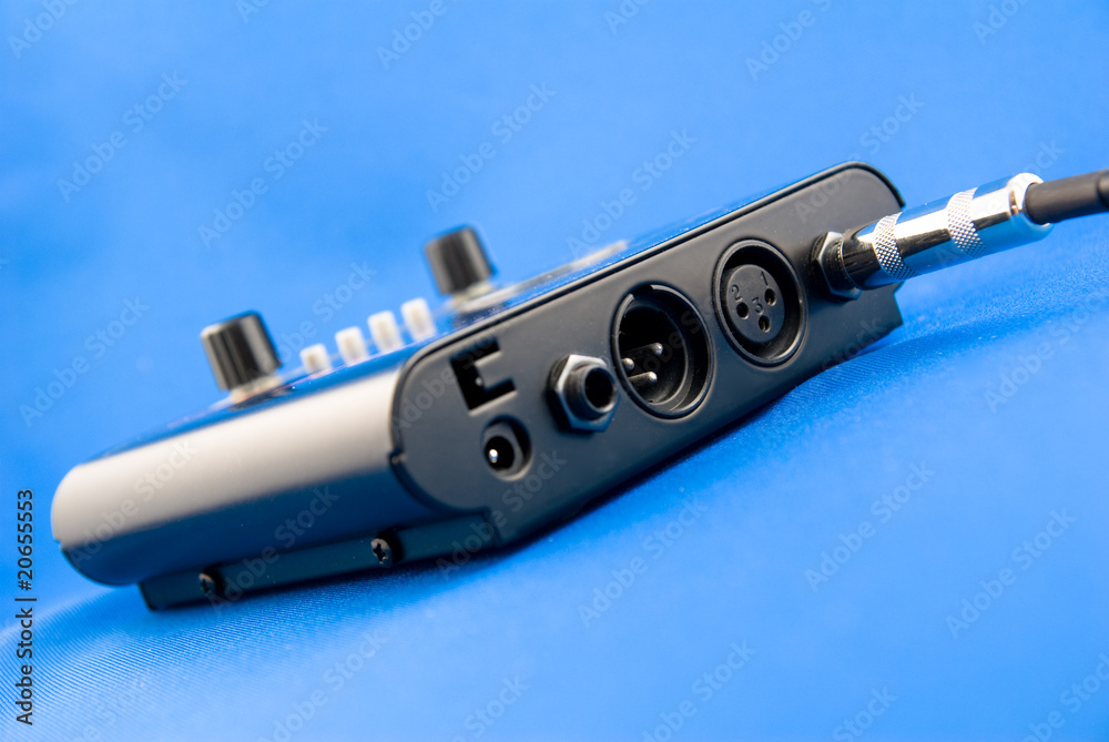 black microfon preamplifier on a blue background Stock Photo | Adobe Stock