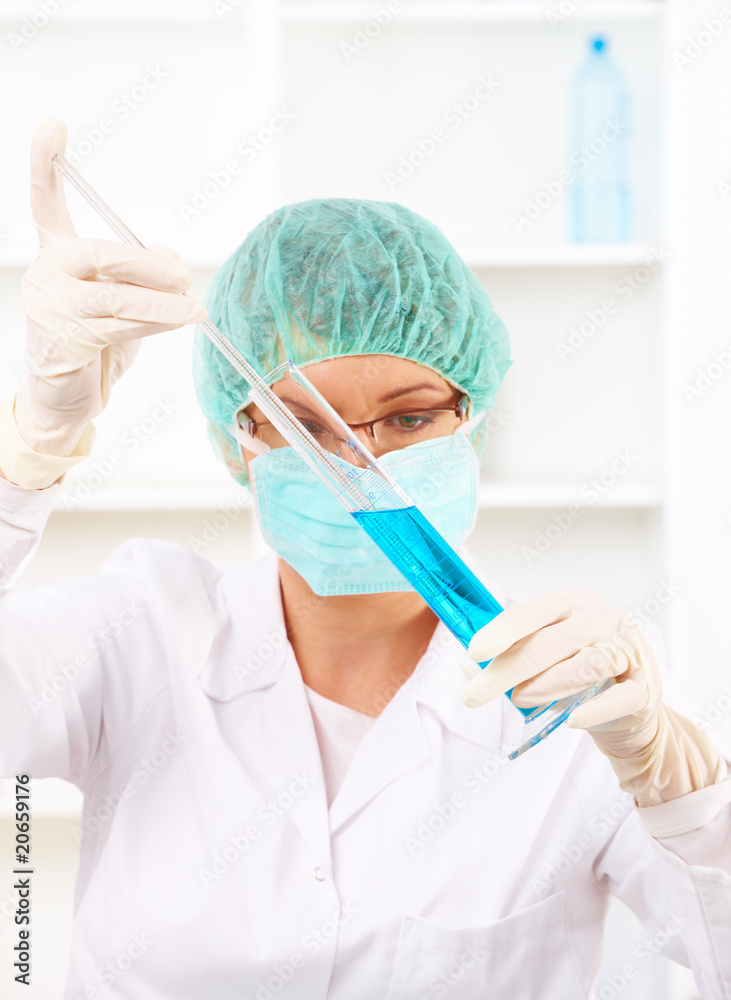 Closeup of a female researcher holding up a test tube Closeup of a female researcher holding up a test tube