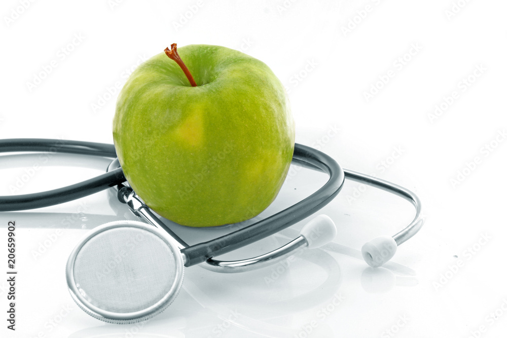 Stethoscope and green apple on white background Stethoscope and green apple on white background