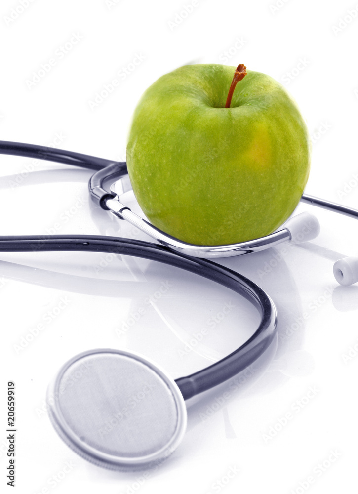 Stethoscope and green apple on white background Stethoscope and green apple on white background