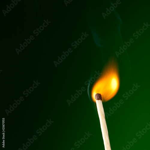 burning match on green