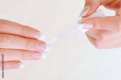 Woman brushing fingernail using with enamel