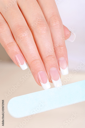 Female  polishing nails on hand with nailfile